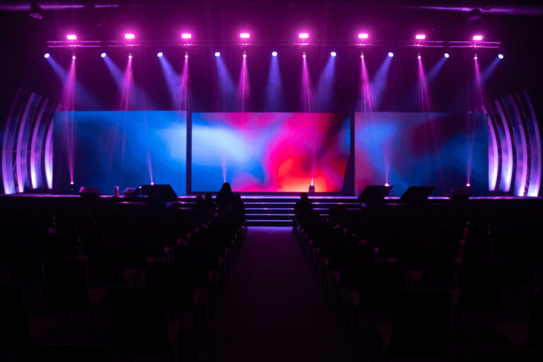 Front view of the stage event with a big LED screens and purple